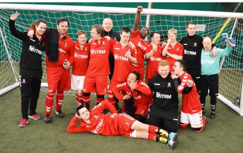 The whole Upbeats team enjoying themselves next to goal 