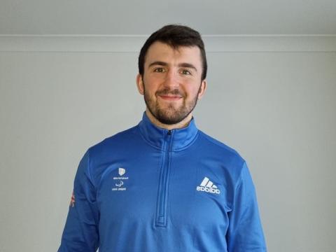Persom in blue top smiling at camera