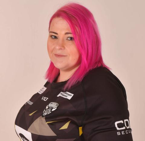 Person with pink hair smiling at camera
