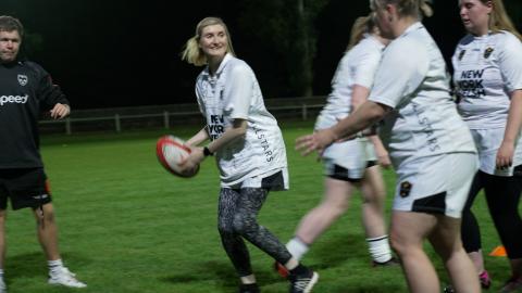 Dragons RFC - Women's team training with ball mid pass between players