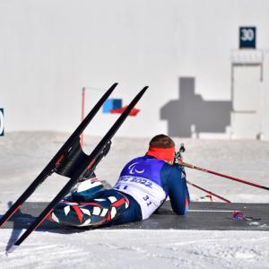 Althlete laying on the floor ready to shoot target